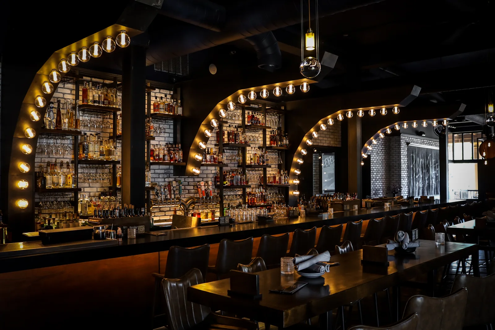 BlackSheep’s illuminated brass arches and bar stools