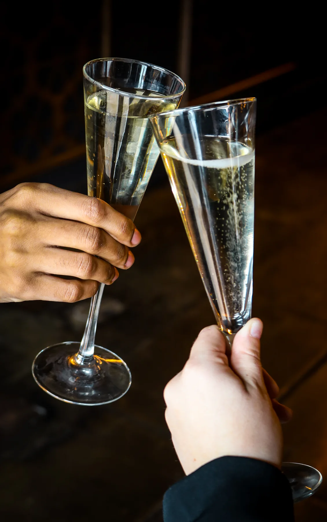 Two glasses of sparkling wine raised in a toast at BlackSheep