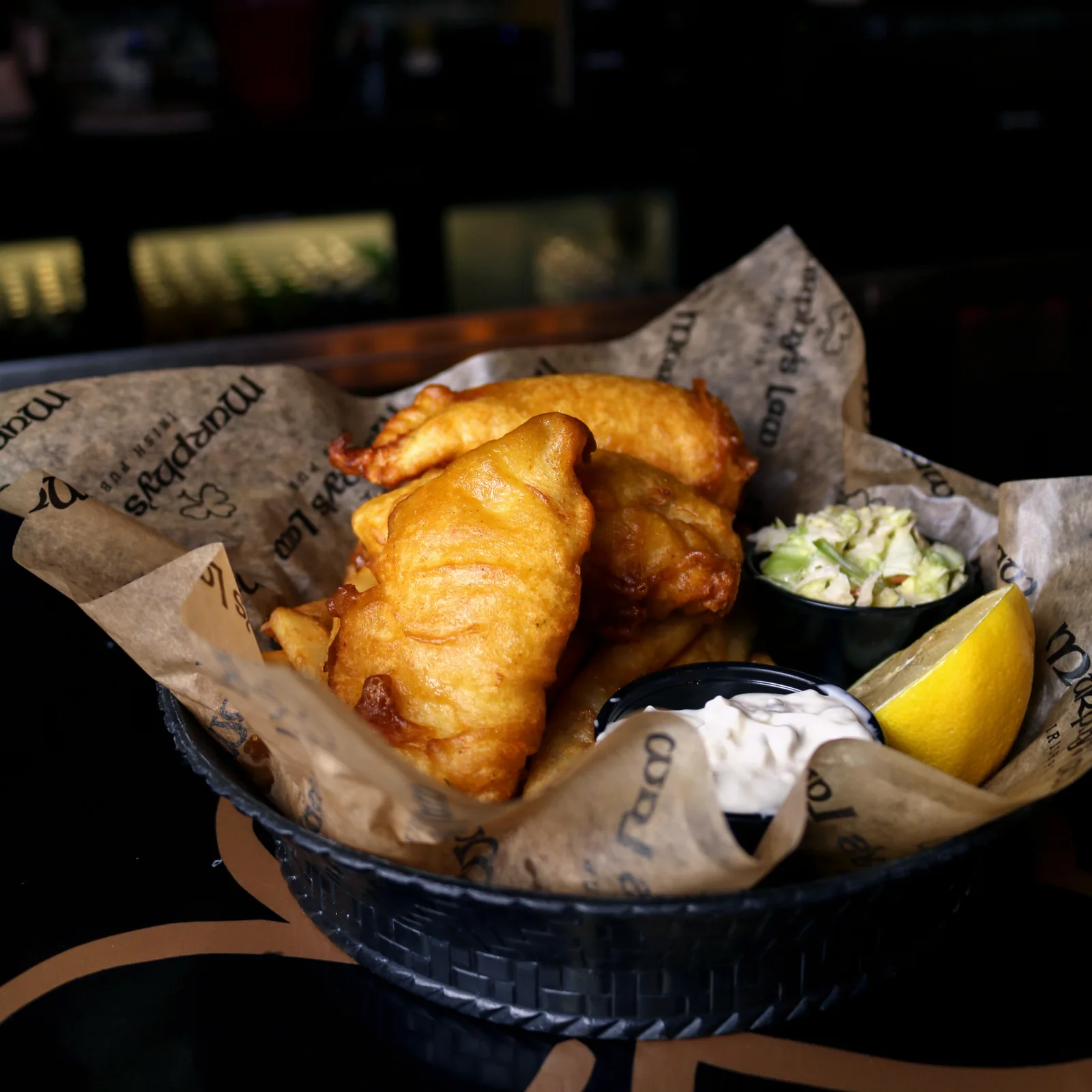 Golden battered fish and chips with lemon at Murphy’s Law