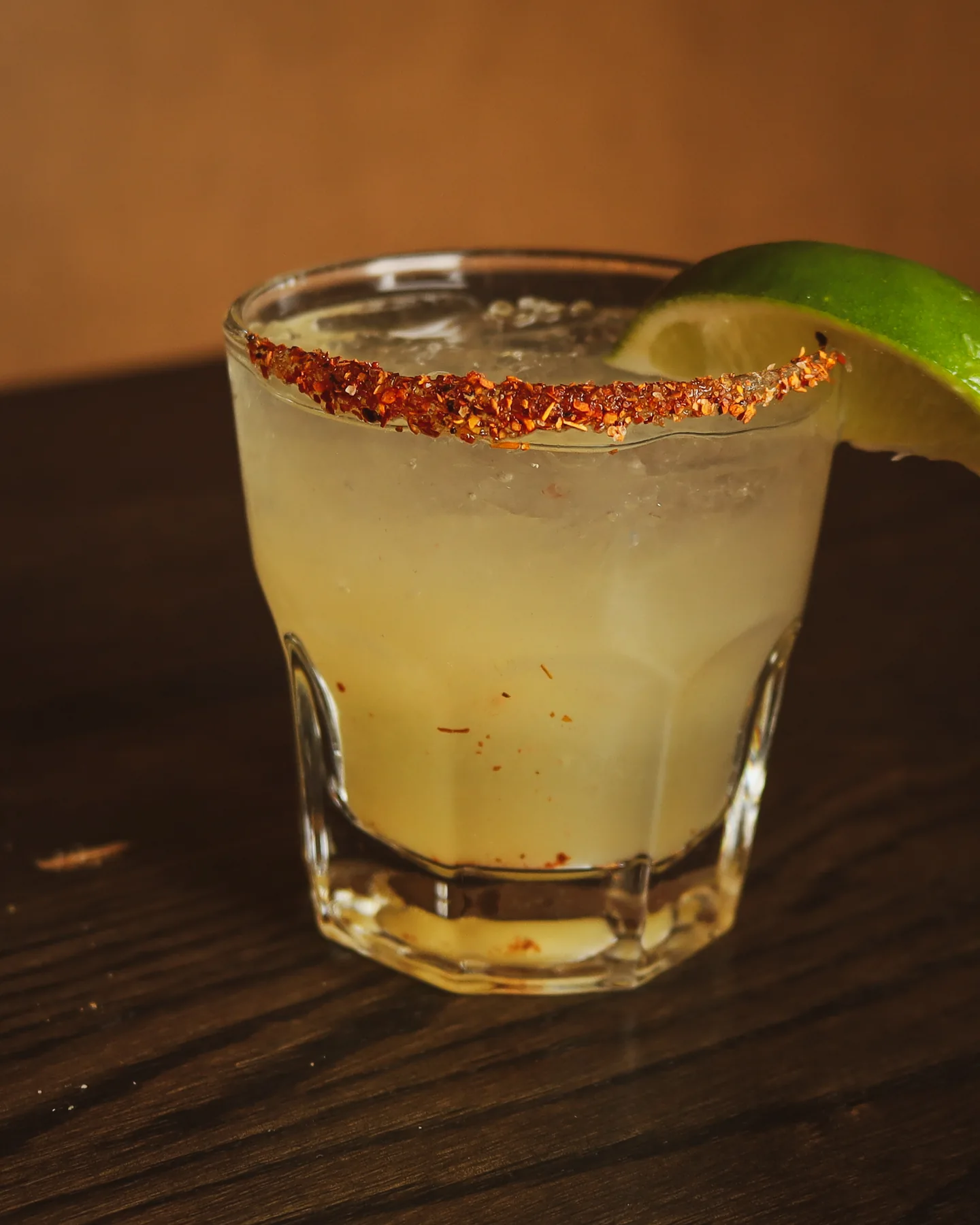 A cocktail with a seasoned rim and lime at Rebel & Rogue
