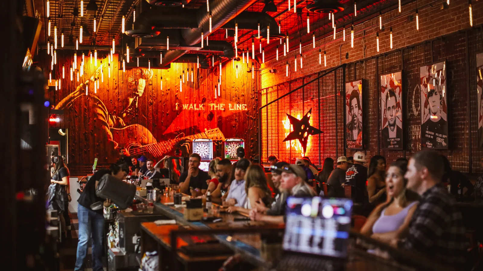 Guests gathered beneath warm pendant lights at Rebel & Rogue